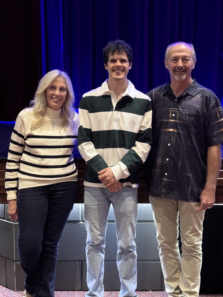 Michael O'Brien with guests in front of the Gem Theater stage