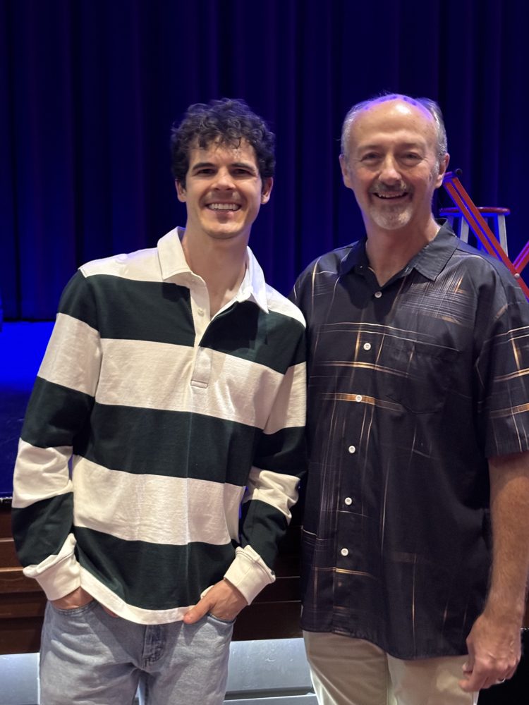 Michael O'Brien with a guest in front of the stage