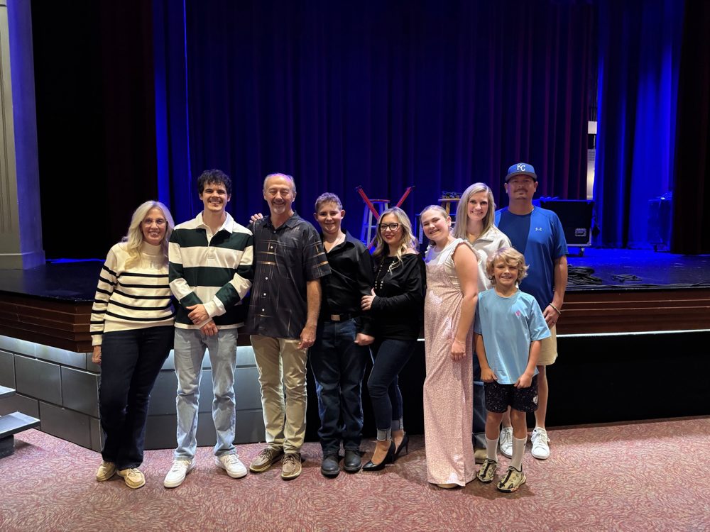 Michael O'Brien with families and guests in front of the stage