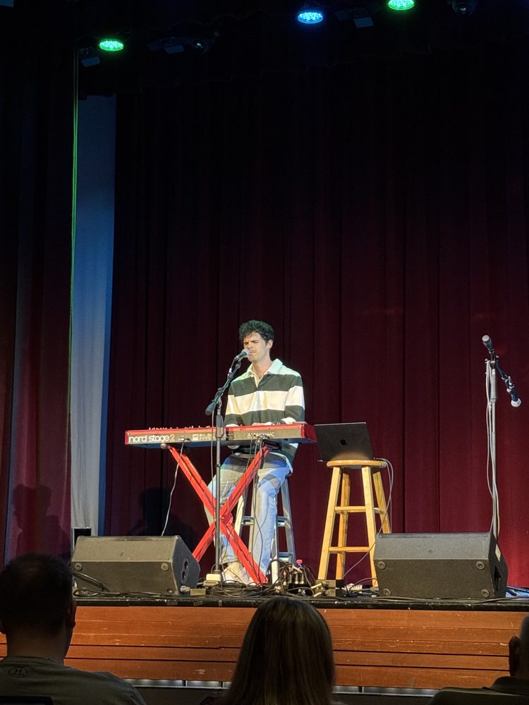 Michael O'Brien singing at the keyboard on stage
