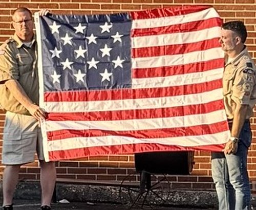 Two Scouts holding a folded American flag