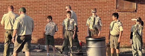Scouts gathered around a retirement fire during the flag ceremony