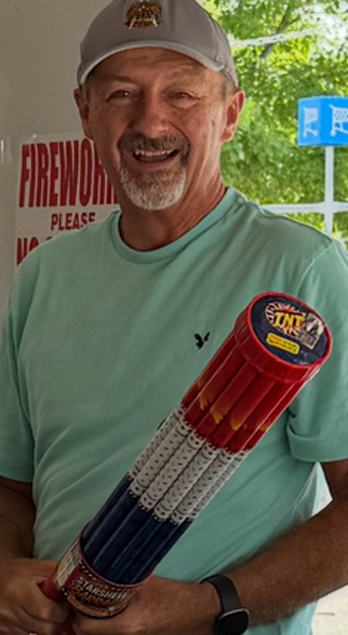 Lodge member holding a large TNT firework