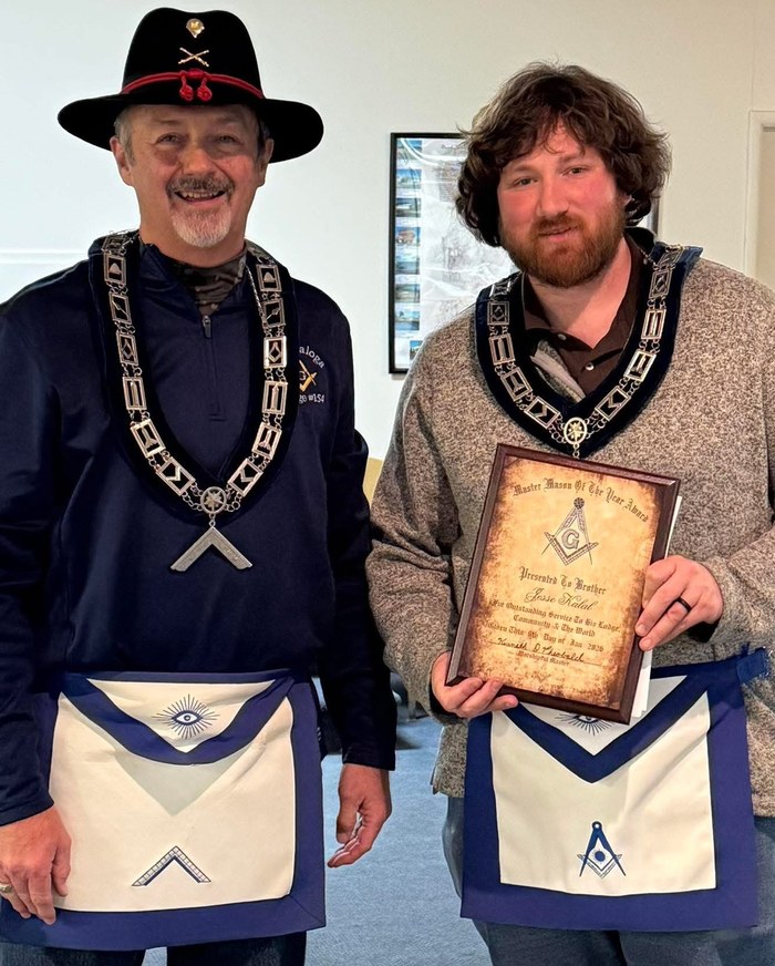 Worshipful Master Ken Theobald presenting Brother Jesse Kalal with the Master Mason of the Year award